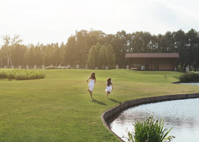 long-shot-mother-daughter-running-outdoors